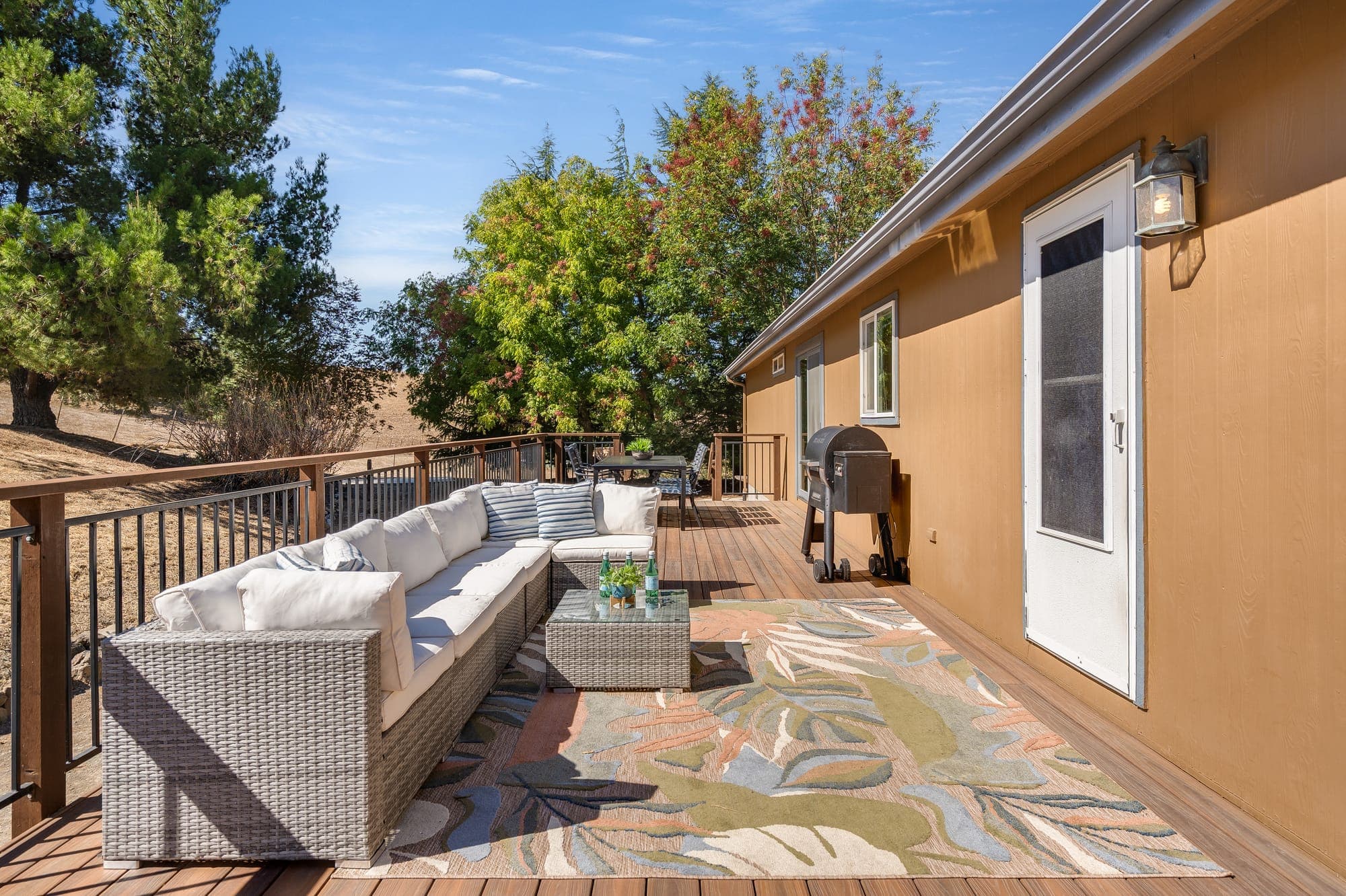 Outdoor lounge seating on the wraparound deck.
