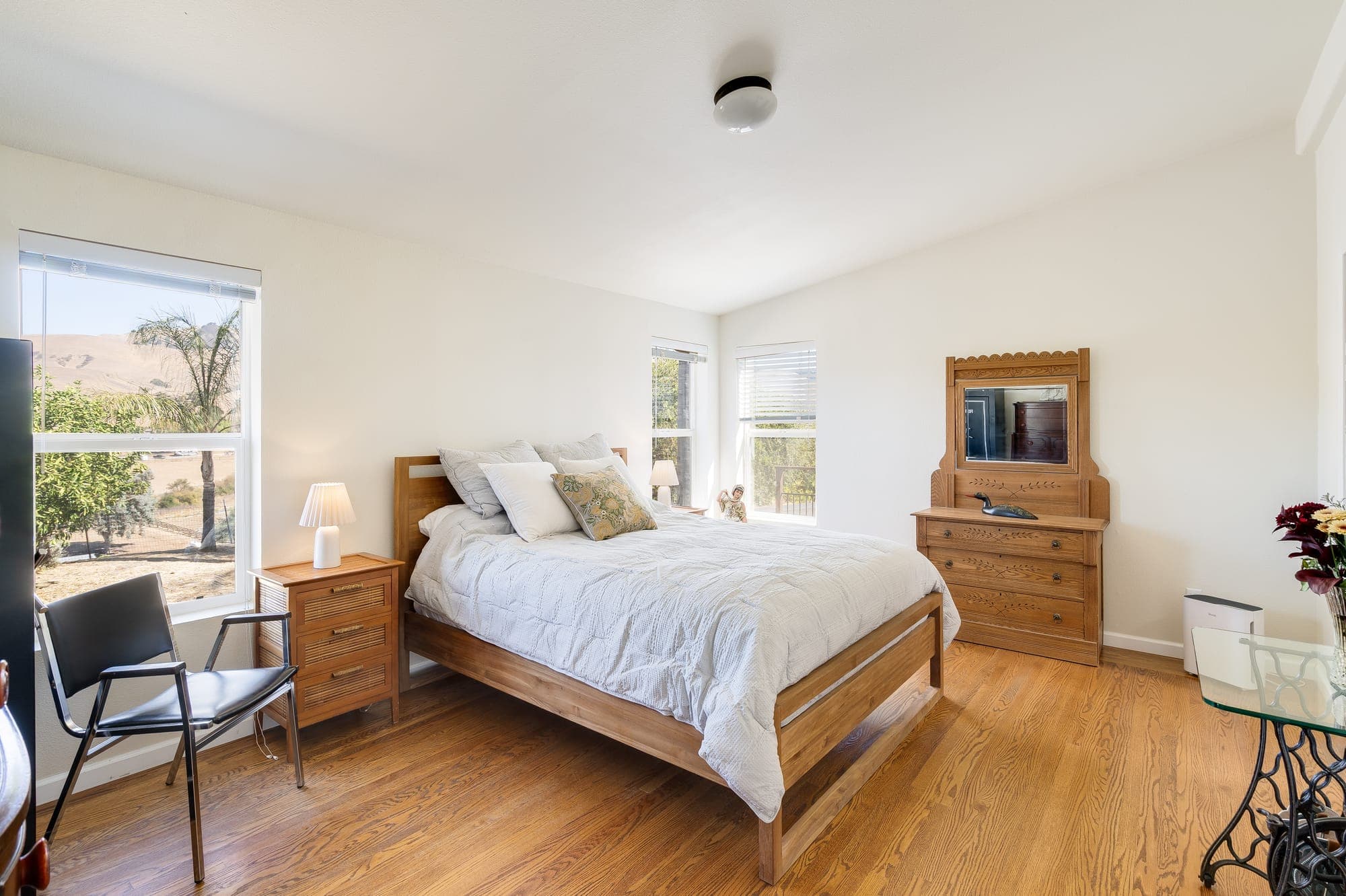 A bedroom with windows on two sides.