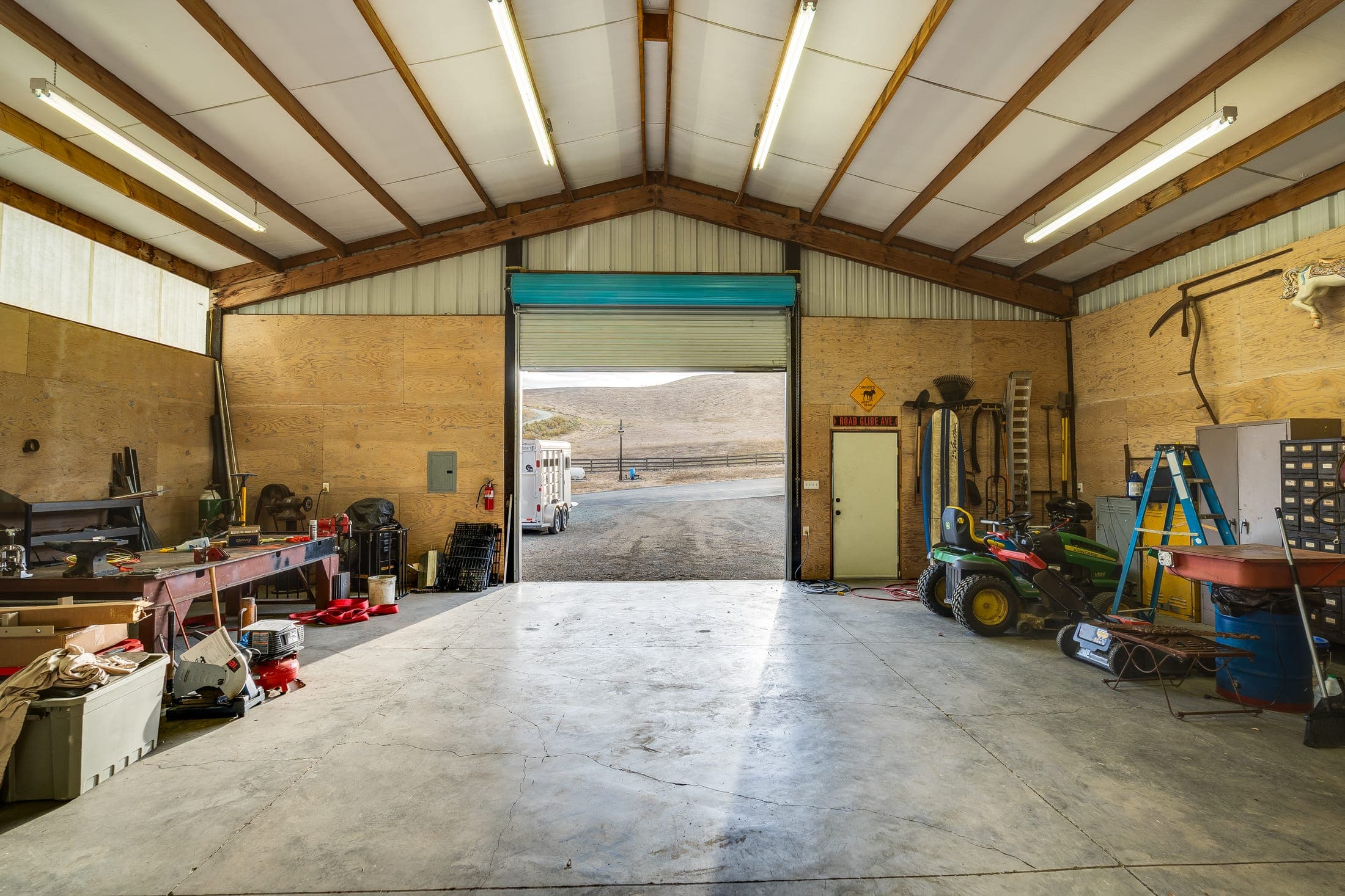Inside the shop, looking out through the roll-up door.